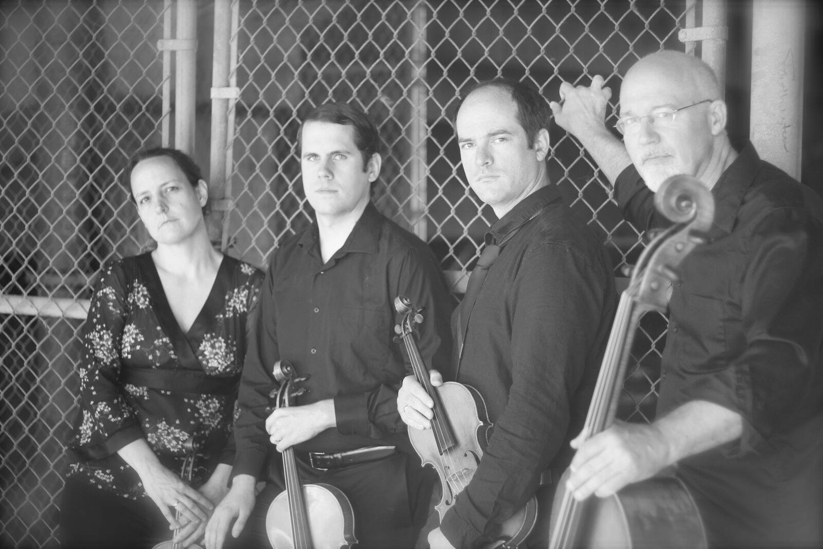 Four classical musicians standing