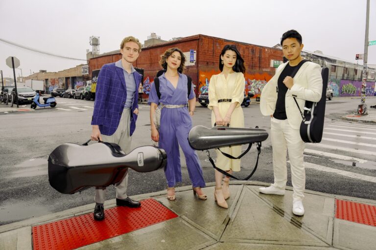 four individuals in their mid-twenties holding string instrument cases.